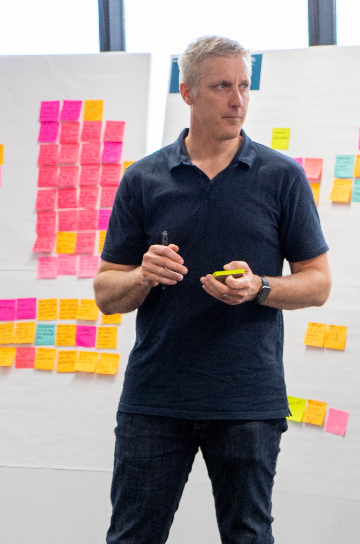 Simon Holbrook facilitating a strategy session in front of a wall of insights