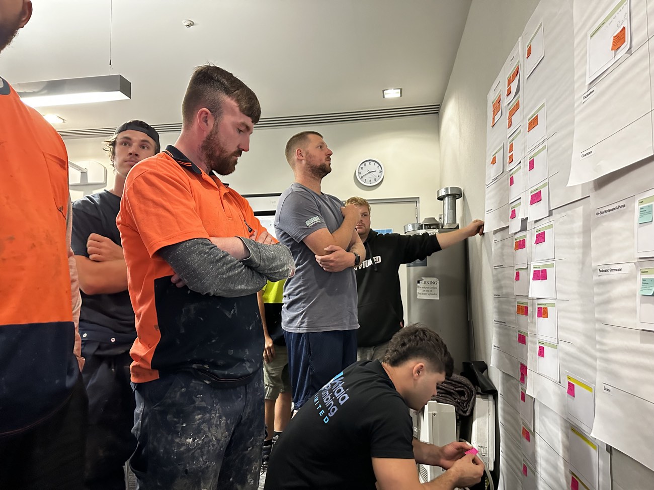 Industry co-design workshop — tradespeople mapping their sector's story on a wall of insights